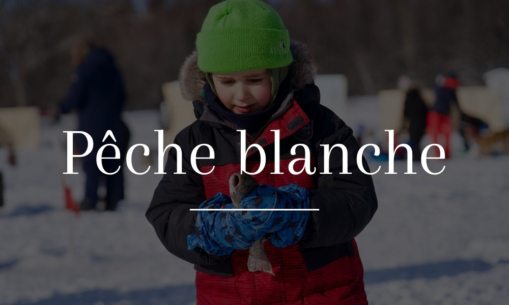 Une enfant tenant une poisson attrapée en pêche blanche